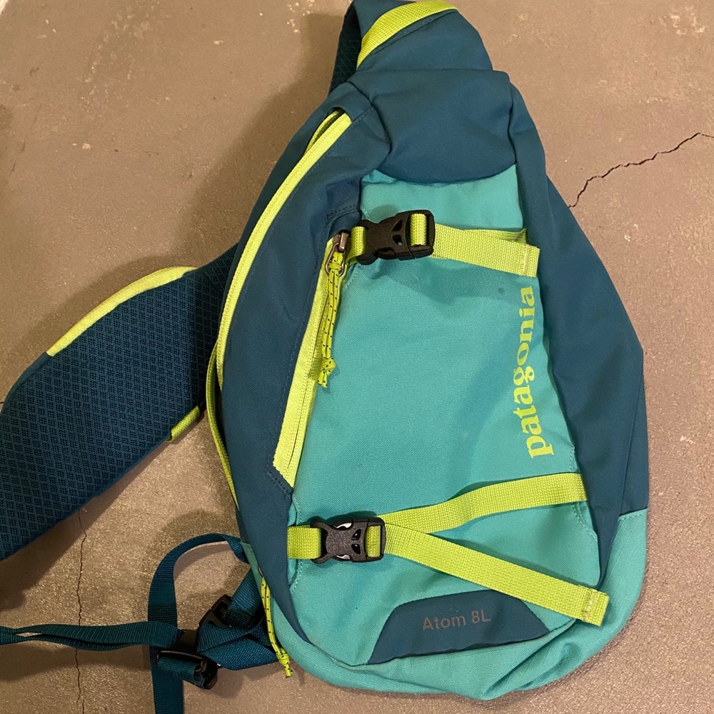 Blue and green Patagonia cross shoulder backpack